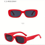 Red sunglasses with dark lenses on a white background